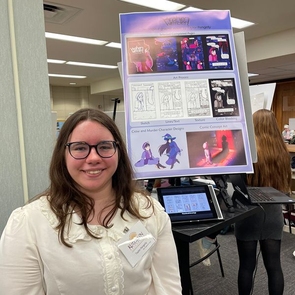 Student in white blouse smiling in front of a purple poster
