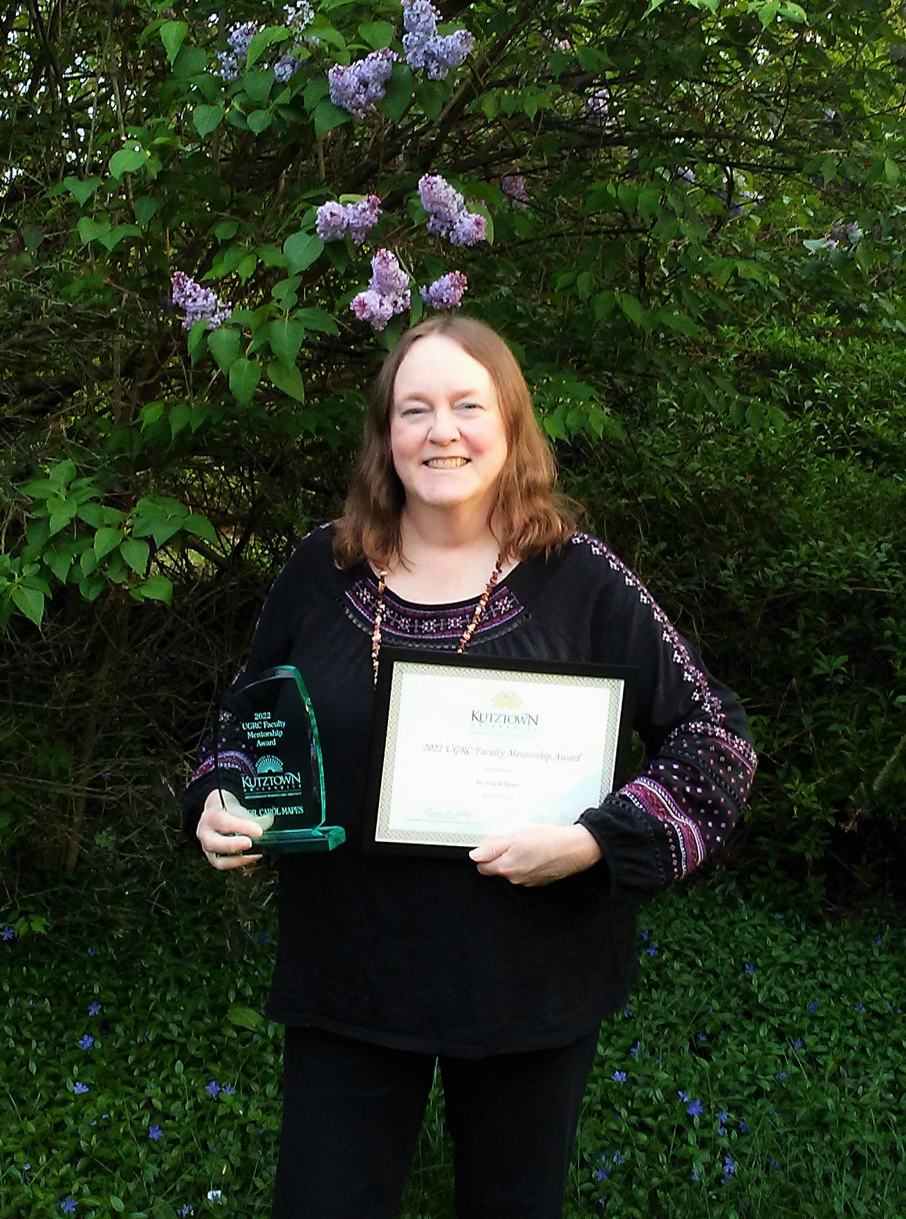 Dr. Carol Mapes poses with her faculty mentorship certificate. 