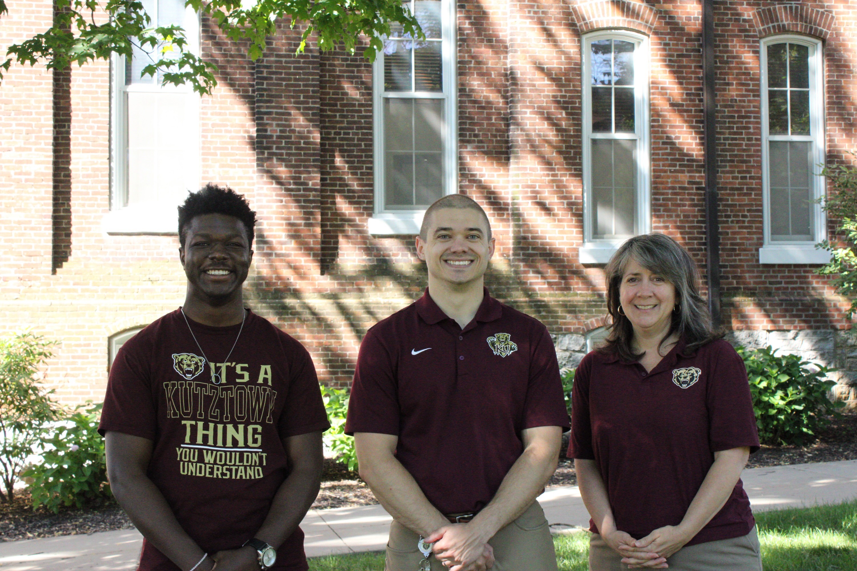 three office of compliance employees standing outside of Old Main