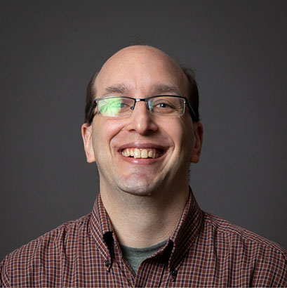 Photo of Sean Erreger in front of grey background