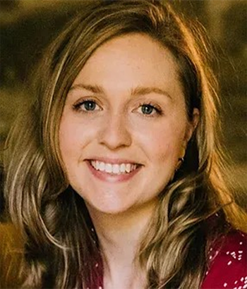 Photo of Alice C. Fischer in front of stone background