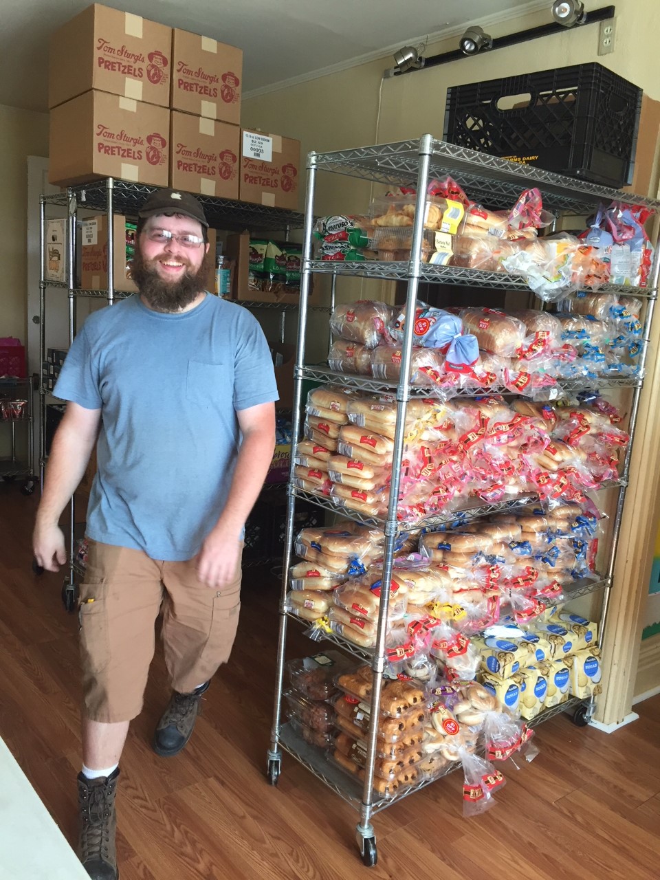 Our Friend Inc Staff, Ryan Tuerk helping stock shelves for the Student Food Pantry.