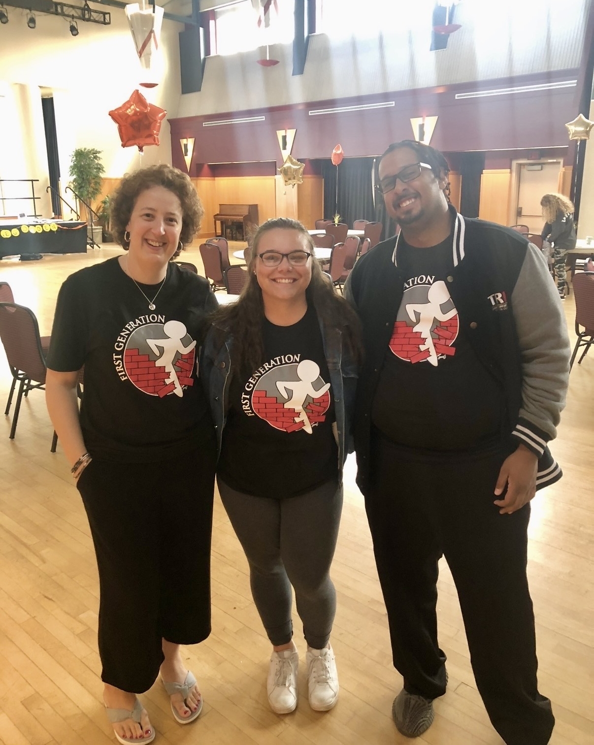 Director, Navigator, and Student standing together at a First Gen celebration