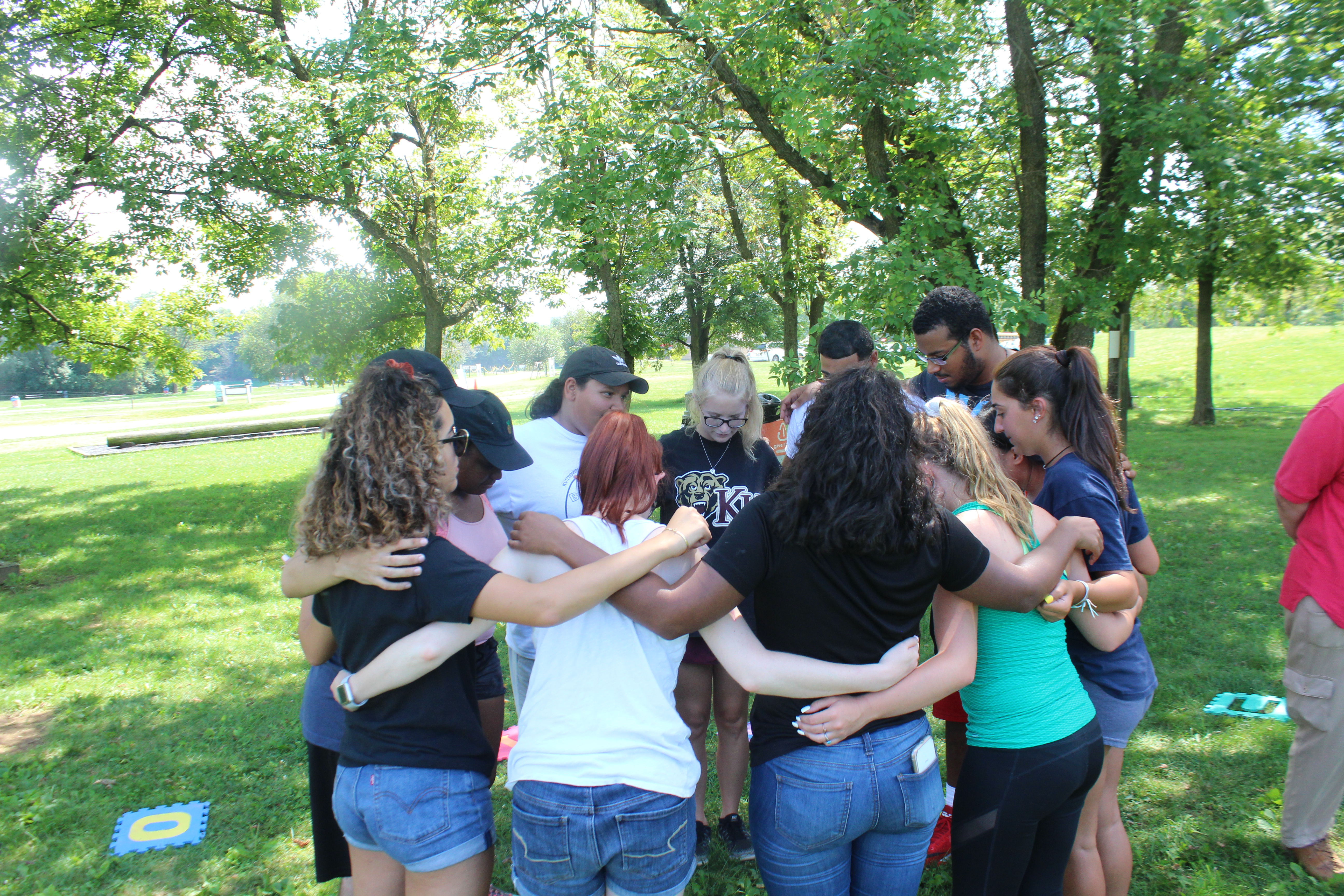 TRIO Mentors in a circle hugging