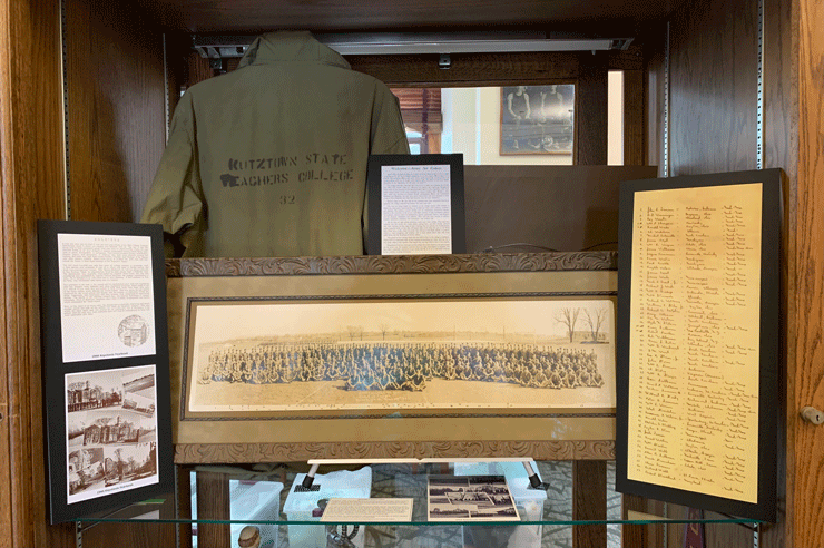 Photo of KU History Display with a  1943 Army Air Cadets Photo, shirt, other historical documents with text. 