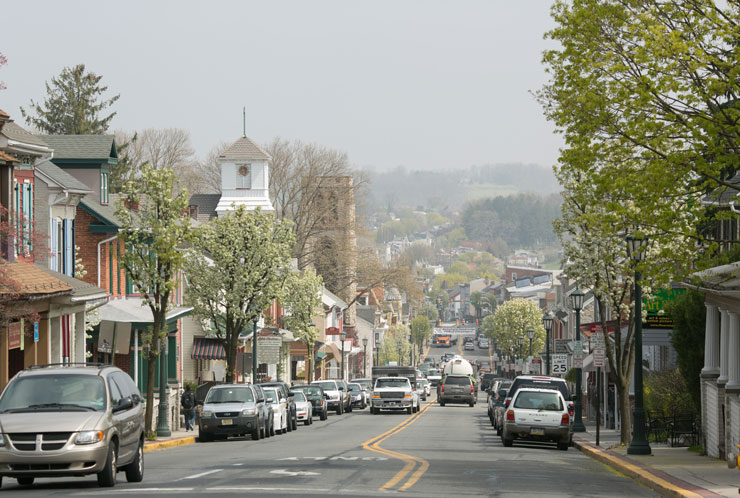 Photo of Kutztown Road lined with cars and buildings in the borough of Kutztown
