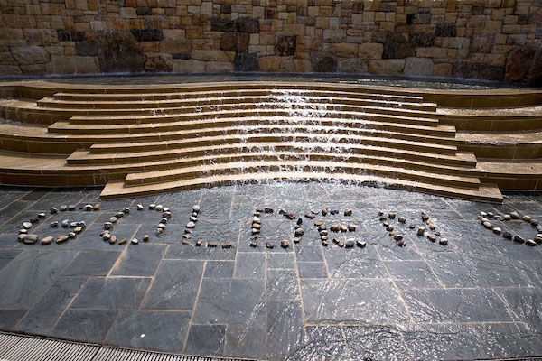 Photo of Alumni Fountain with the word GOLDEN spelled in stones.