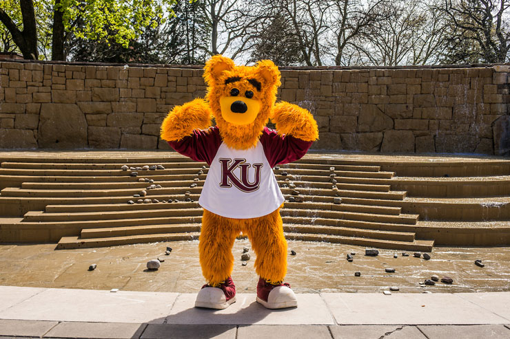 Kutztown University mascot, Avalanche, stands in front of Alumni Plaza posed to show he is KU strong. 