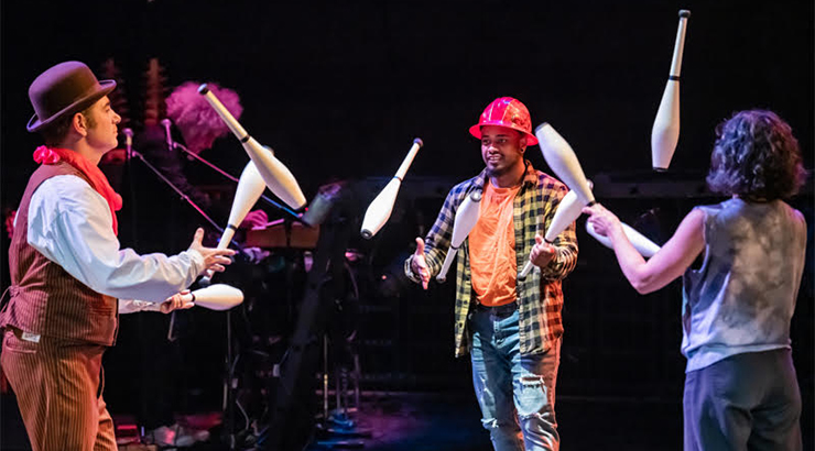 Performers juggling on stage