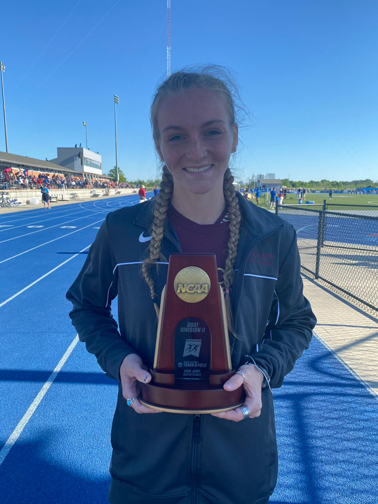 Becca Hemingway poses for photo op with sixth place trophy for high-jump at the 2021 NCAA Division II Outdoor Championships. 