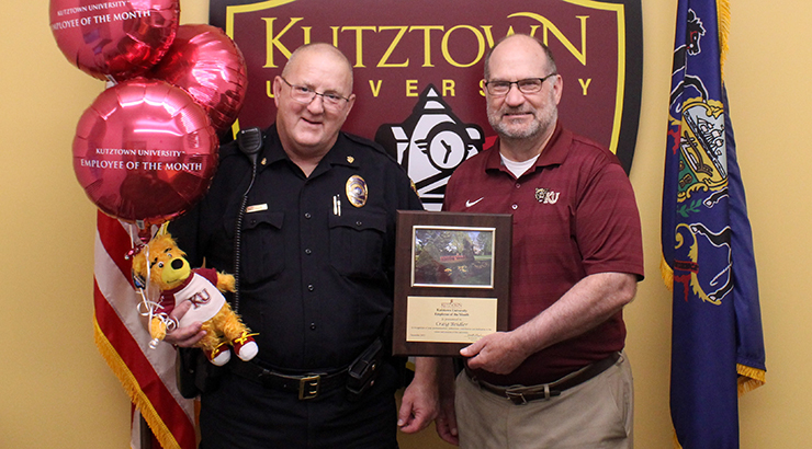 Photo of Craig Beidler being presented the employee of the month plaque from Dr. Hawkinson