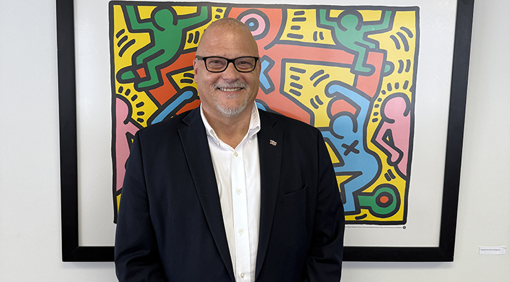 Cavalier standing in front of artwork