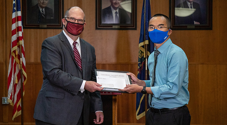 Dr. Hawkinson (left) presents Dr. Albert Fu (right) with the Chambliss Faculty Research Award. 