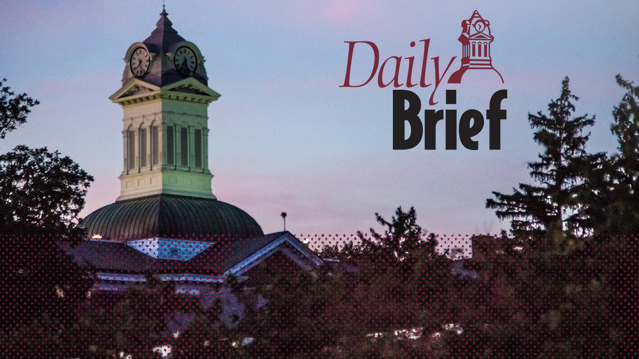 Old Main Tower during sunset with Daily Brief logo next to it