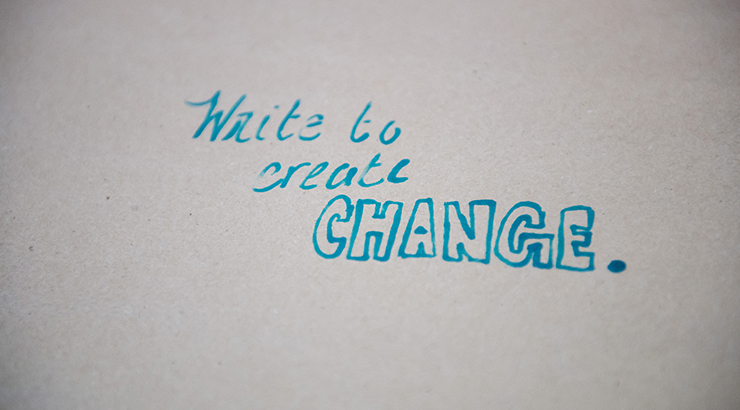 Write to Create Change on piece of paper.