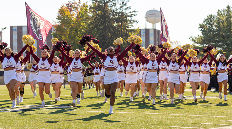 Cheerleaders running on football field