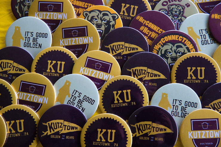 A variety of Kutztown University pins with various images on each one.