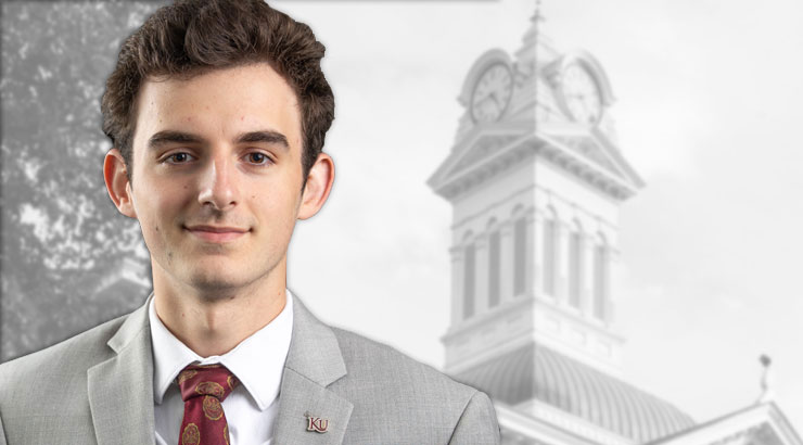 Photo of Evan Santos in a suit and tie. Background gray photo of the clock tower.