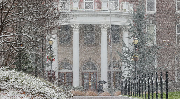 Photo of snow falling in front of Old Main.