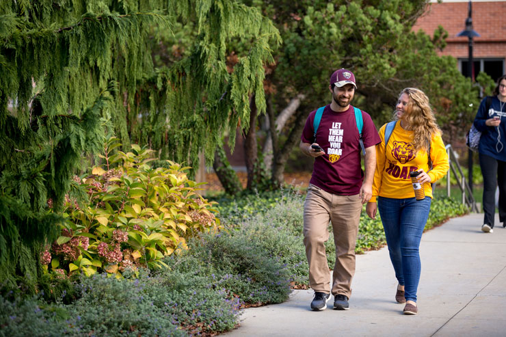 Photo of two students walking.
