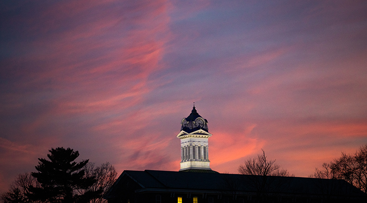 distant shot of the Old Main clock tower at sunset 