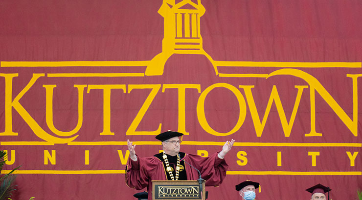 Kutztown University president, Dr. Kenneth Hawkinson, welcomes graduates  and families from the stage during one of six commencement ceremonies.  