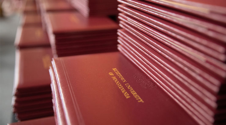 Stack of maroon diplomas
