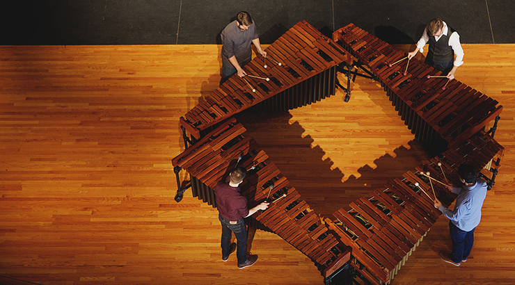 Overhead view of marimba performers on stage.