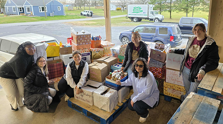 Staff and students with holiday boxes for Friend Inc.