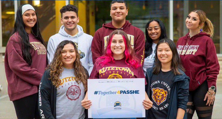 Eight PASSHE students holding a sign #Together4PASSHE.