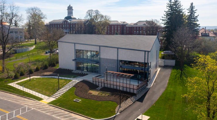 Exterior shot of the Wells-Rapp Center with Old Main building in the distance.