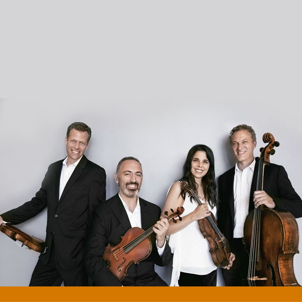 Pacifica Quartet members holding their instruments in a posed shot