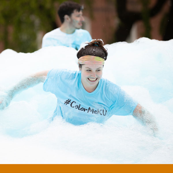 Student using the foam slide during Bearfest