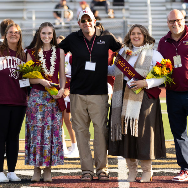 Homecoming spirit court on field at halftime.
