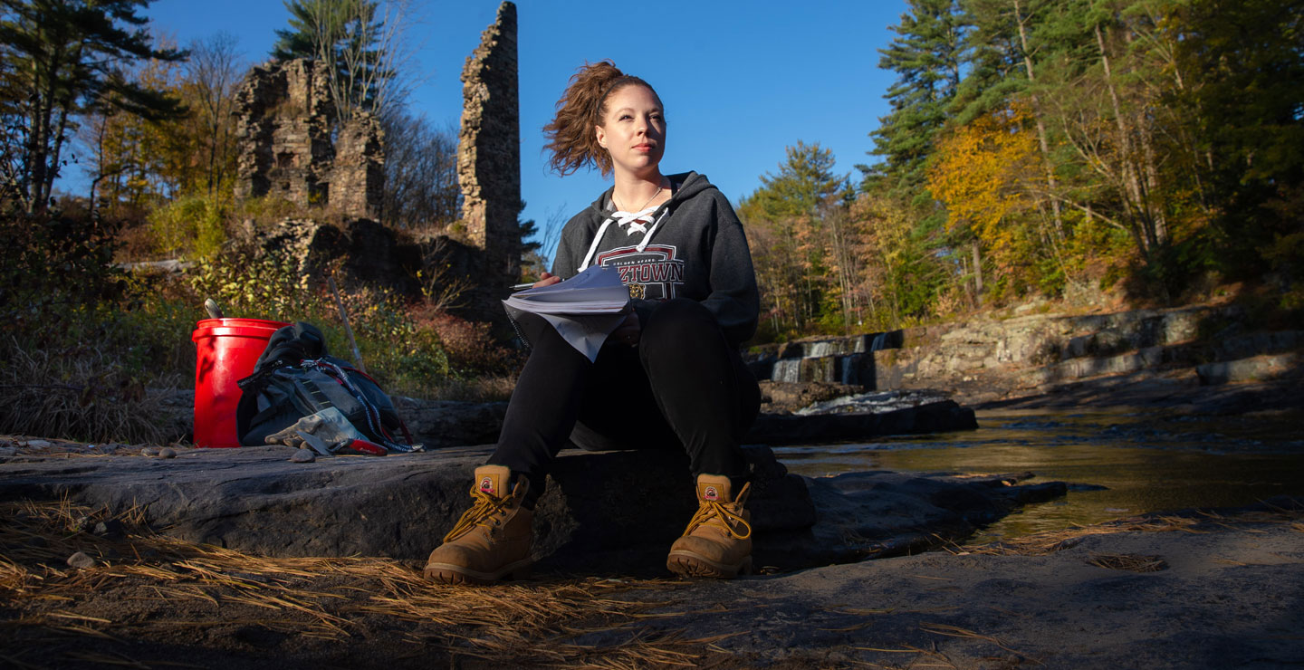 Female anthropology student on location at a field study.