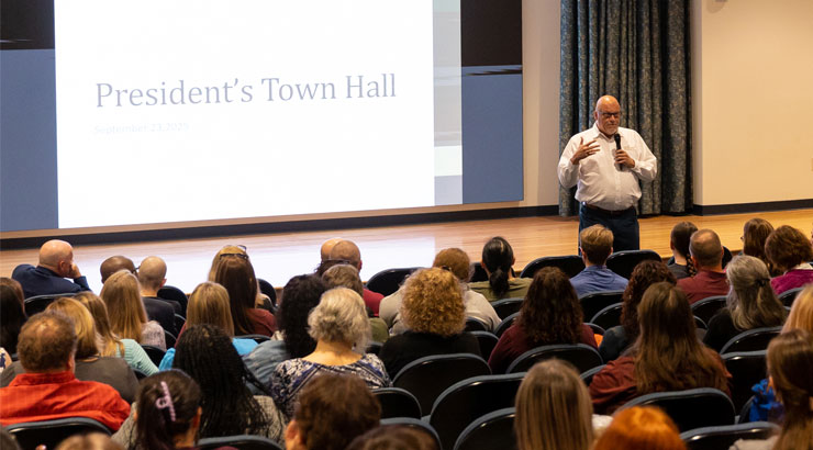 President Cavalier speaks at a town hall.