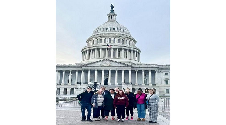 The nine students standing in front of the Capital building in Washington. 