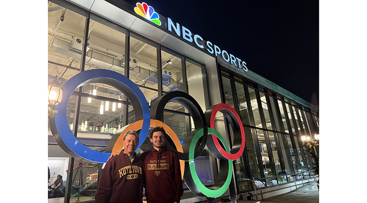 Alumni standing in front of NBC Sports building