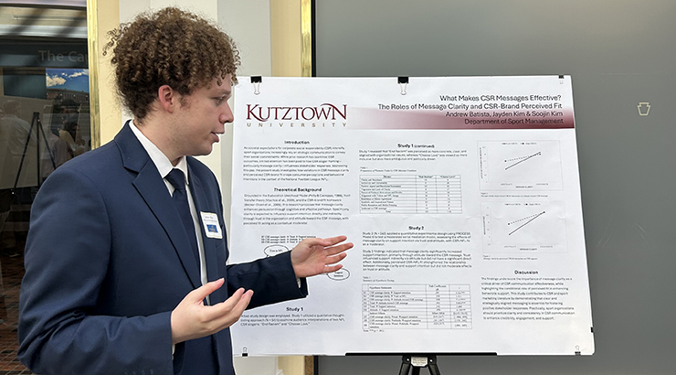 Andrew Batista with a poster presentation
