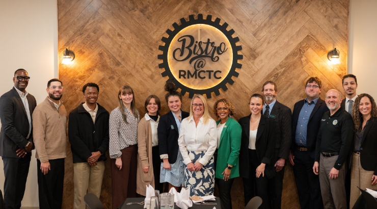 Group Photo of people in front of a Bistro at RMCTC sign