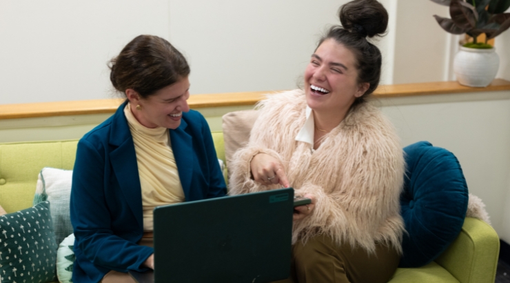 Two people in front of a whiteboard