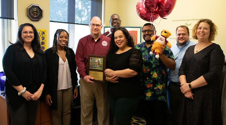 Group photo of President Hawkins and staff celebrating Melinda Quiñones, employee of the month for September 2021