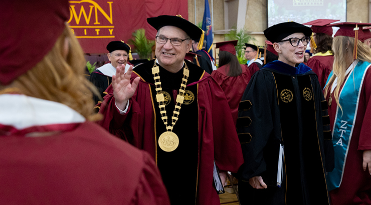 Photo of Dr. Kenneth Hawkinson processing at commencement