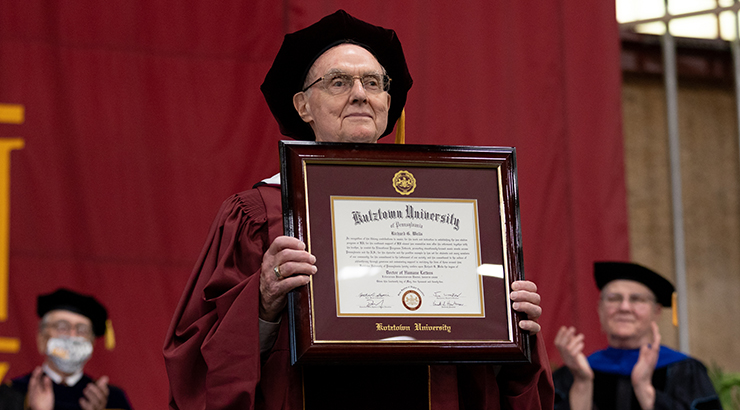  Richard Wells holding an honorary doctorate at the institution's 2022 Spring Commencement Ceremony
