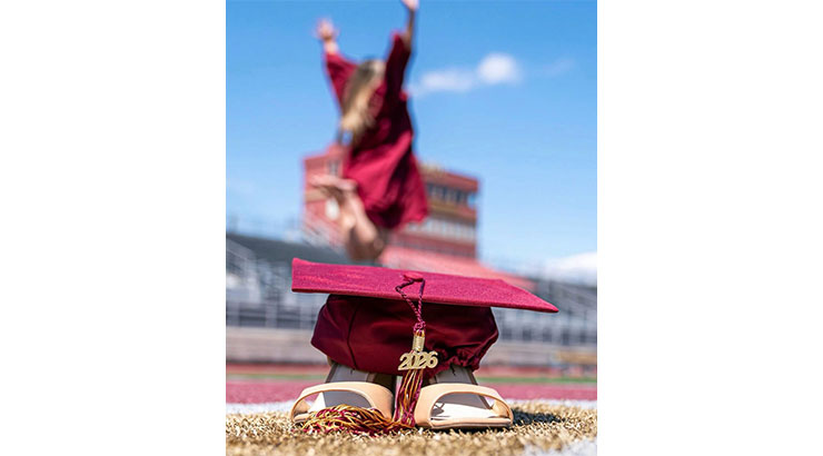 cap and shoes with girl jumping in background