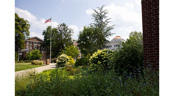 looking at Old Main with flag in the foreground
