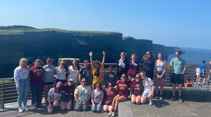 group photo in Ireland at the Cliffs of Moher