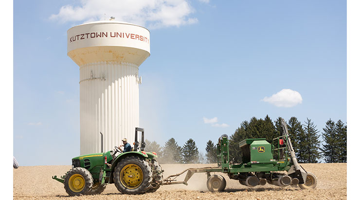 tractor in front of water tower