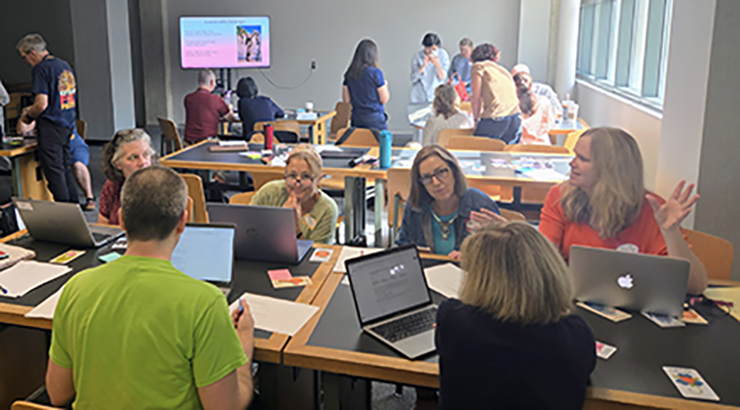 Faculty sitting at tables