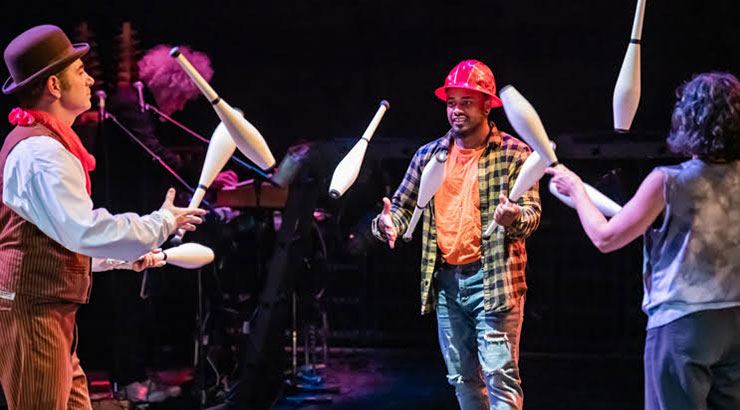 Performers juggling on stage